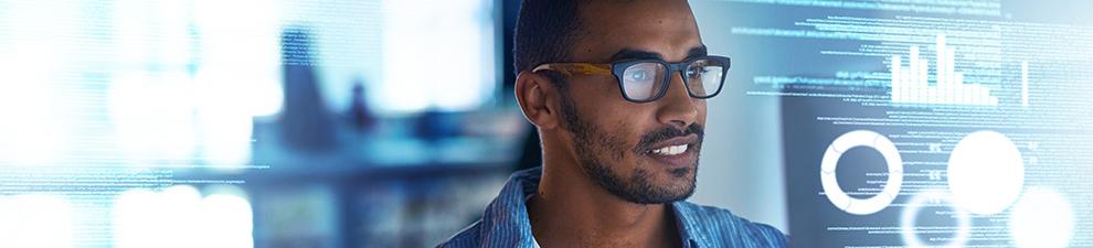 Image of a person looking at computer code on a monitor.